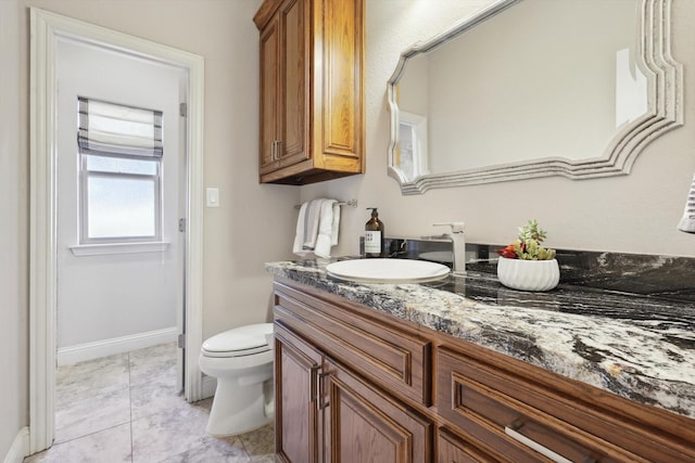 bathroom with tile patterned floors, vanity, and toilet