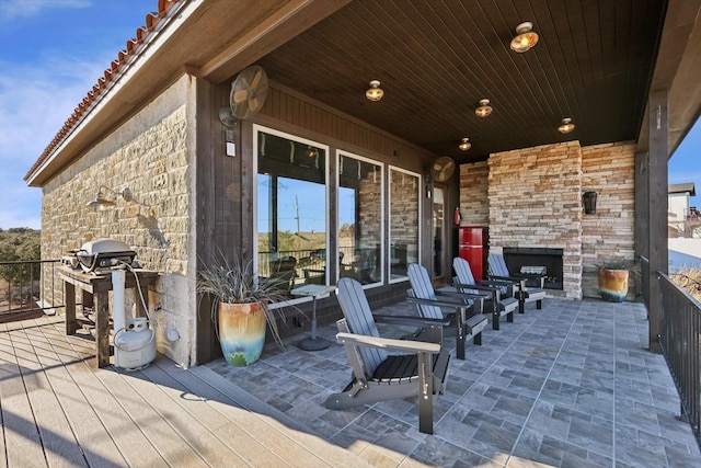 view of patio featuring grilling area and an outdoor stone fireplace