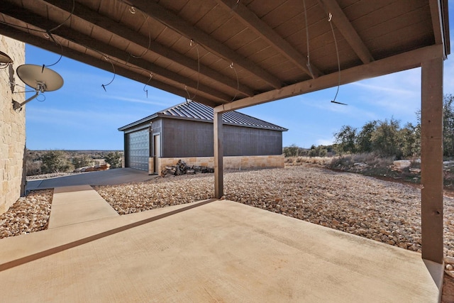 view of patio featuring a garage and an outdoor structure