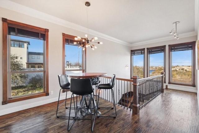 dining space featuring an inviting chandelier, ornamental molding, and dark hardwood / wood-style floors