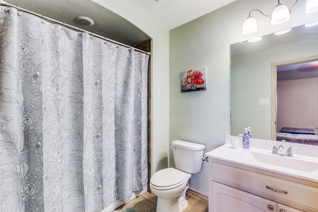 bathroom with vanity, tile patterned floors, and toilet