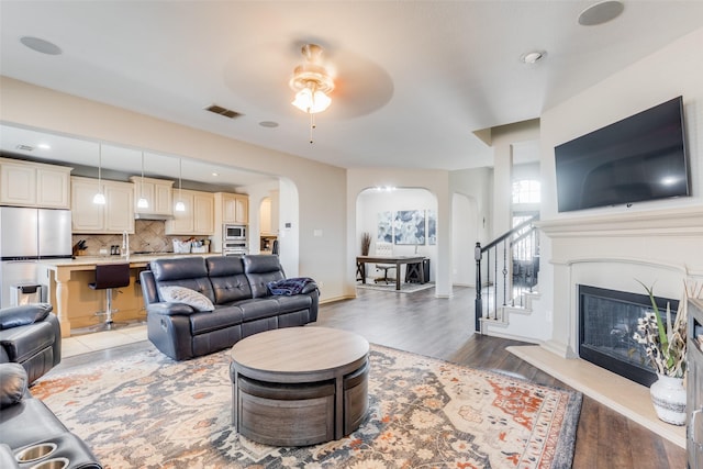 living room featuring ceiling fan and light hardwood / wood-style floors