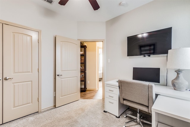 carpeted home office with ceiling fan