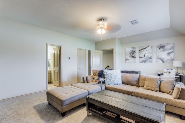 living room featuring light carpet and ceiling fan