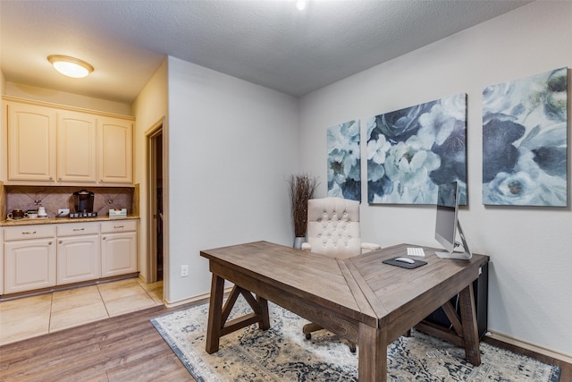 office featuring light hardwood / wood-style flooring and a textured ceiling