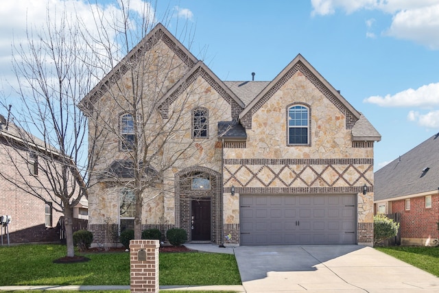 view of front of home featuring a garage and a front yard