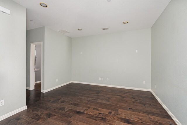 unfurnished room featuring dark wood-type flooring