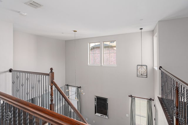 stairway featuring a high ceiling