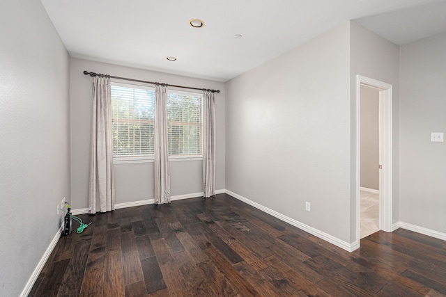 spare room with dark hardwood / wood-style floors