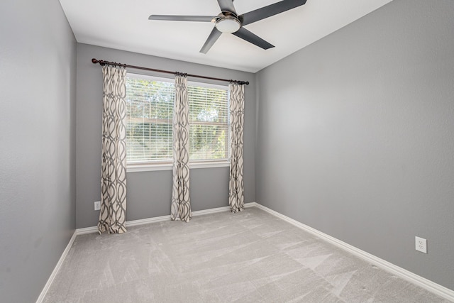 empty room with light colored carpet and ceiling fan