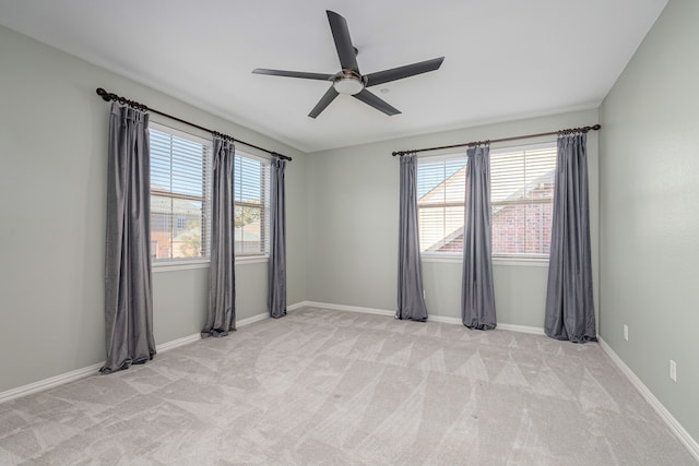 unfurnished room with ceiling fan and light carpet