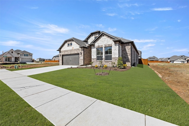 view of front of house featuring a front lawn, stone siding, concrete driveway, a garage, and brick siding