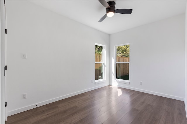 spare room featuring dark wood-type flooring and ceiling fan