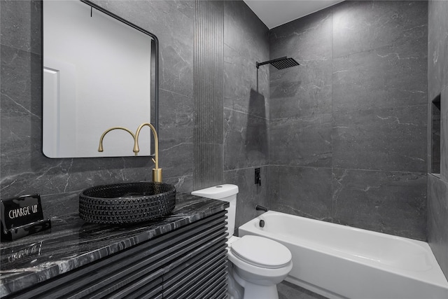 full bathroom featuring vanity, backsplash, tiled shower / bath combo, and toilet