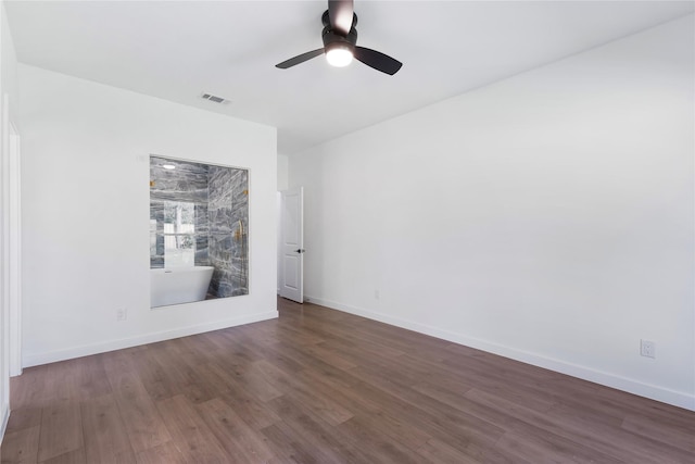 unfurnished room featuring dark wood-type flooring and ceiling fan