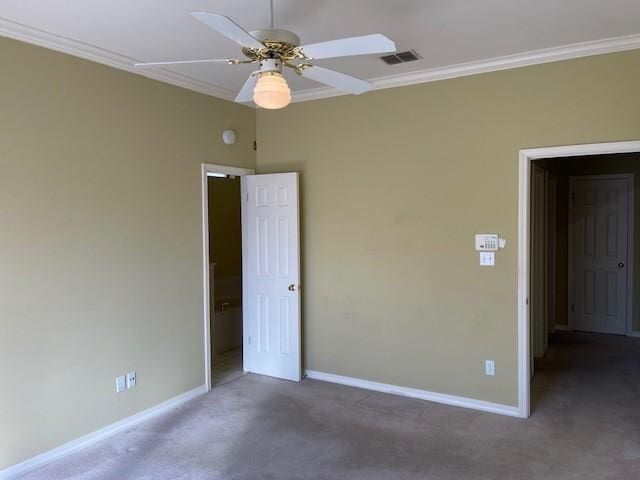 unfurnished bedroom with crown molding, ceiling fan, and dark colored carpet