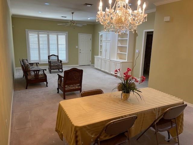 carpeted dining room featuring crown molding and ceiling fan