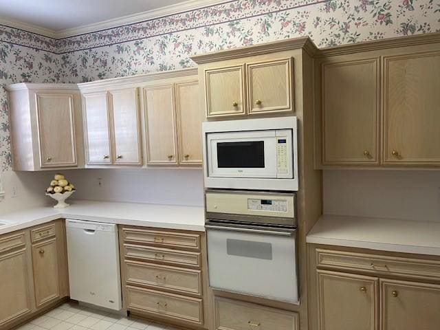 kitchen with crown molding and white appliances