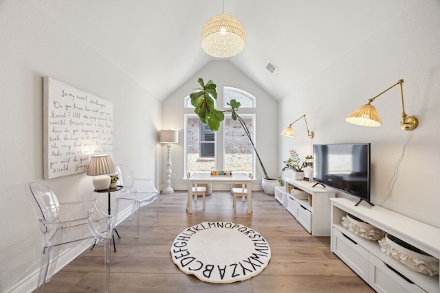 sitting room featuring vaulted ceiling and light wood-type flooring