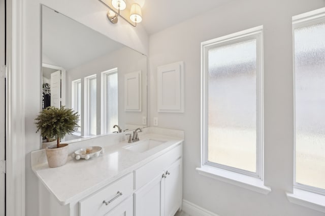 bathroom with vanity and vaulted ceiling