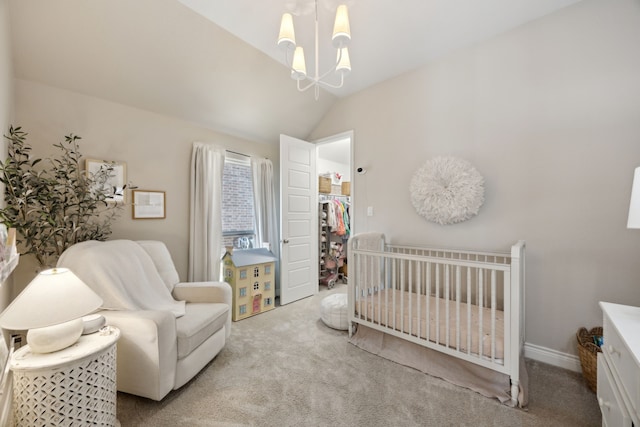 carpeted bedroom featuring vaulted ceiling, a nursery area, and a chandelier