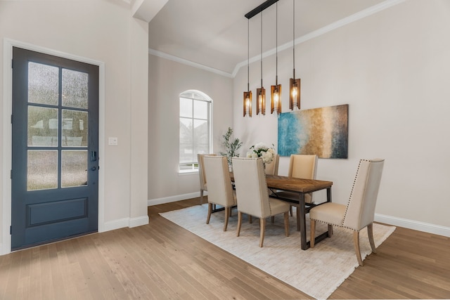 dining space featuring hardwood / wood-style flooring and ornamental molding