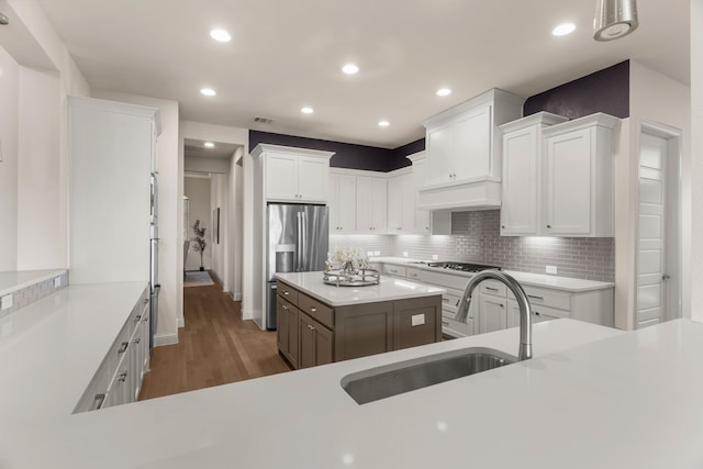 kitchen with tasteful backsplash, sink, and white cabinets