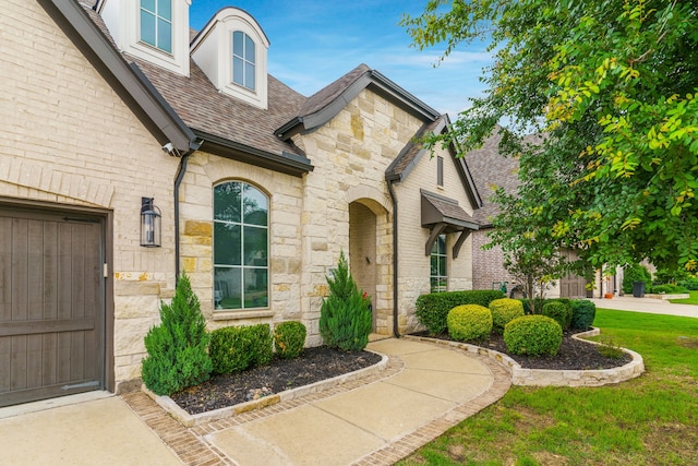 entrance to property with a lawn