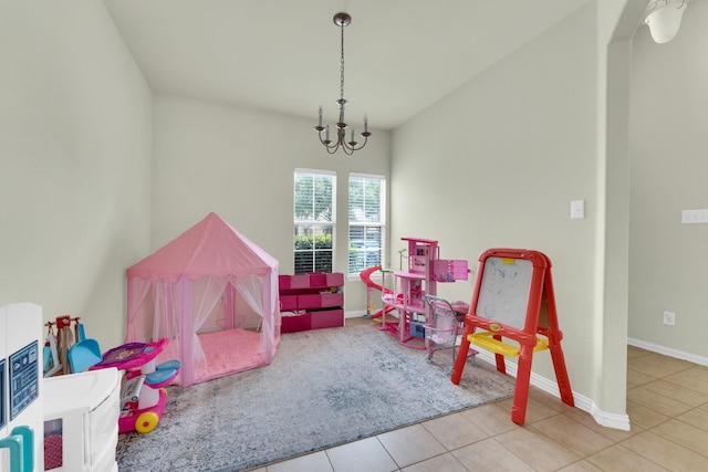 playroom featuring tile patterned flooring and a notable chandelier