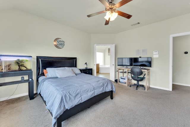 bedroom with ceiling fan, carpet flooring, and ensuite bath