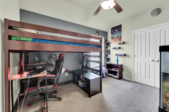 carpeted bedroom featuring ceiling fan and vaulted ceiling