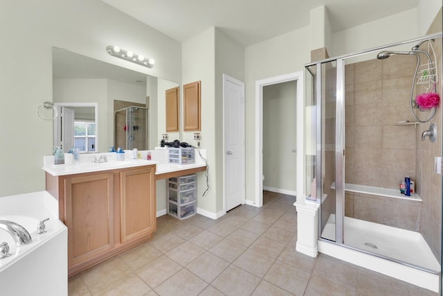 bathroom featuring shower with separate bathtub, vanity, and tile patterned floors