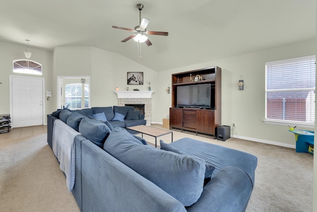 carpeted living room featuring lofted ceiling, a brick fireplace, and ceiling fan