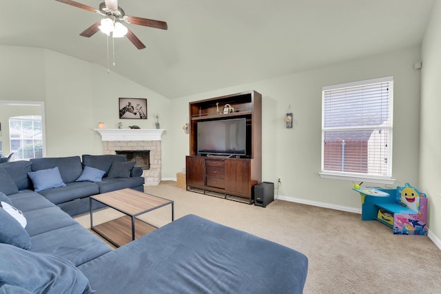 living room featuring light carpet, a fireplace, lofted ceiling, and ceiling fan