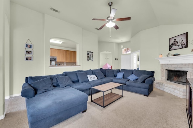 carpeted living room featuring vaulted ceiling and ceiling fan