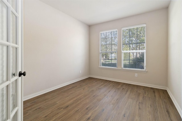 empty room with dark wood-type flooring