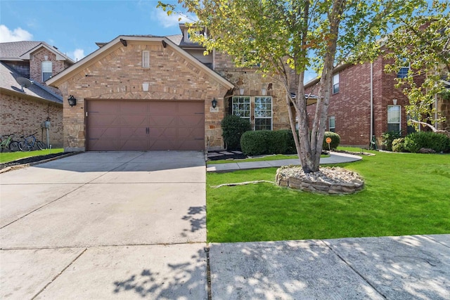 view of front of property featuring a garage and a front lawn