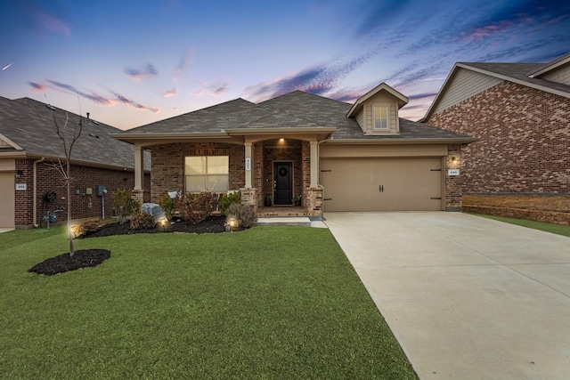 view of front facade featuring a garage and a lawn