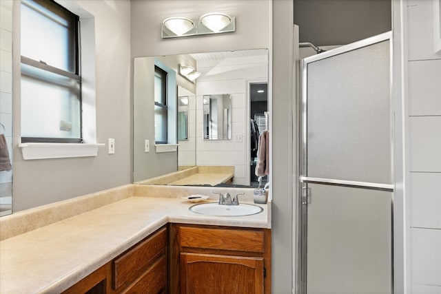 bathroom with an enclosed shower and vanity