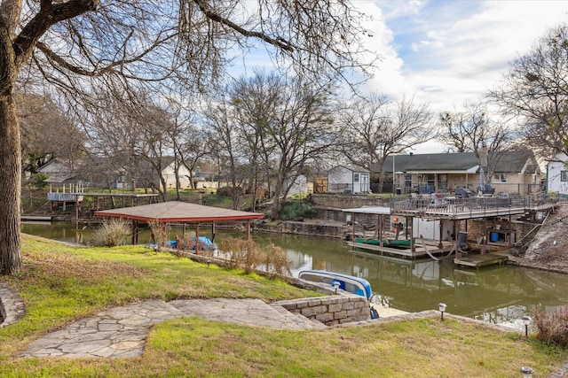 dock area featuring a water view and a yard