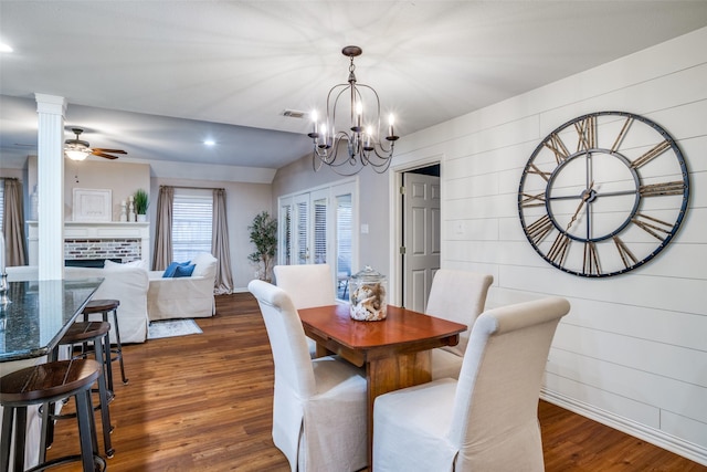 dining area featuring dark wood-type flooring and ceiling fan with notable chandelier