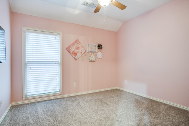 spare room with vaulted ceiling, ceiling fan, and carpet floors