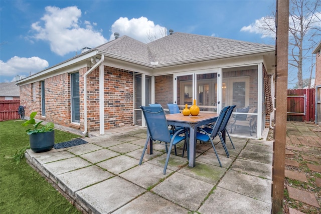 view of patio featuring a sunroom