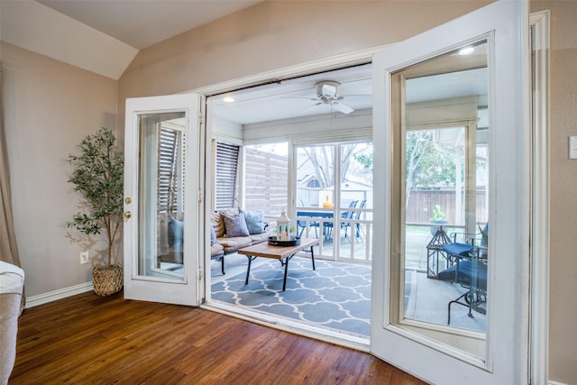 doorway to outside with lofted ceiling, dark hardwood / wood-style floors, and ceiling fan