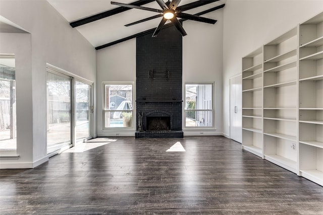 unfurnished living room featuring high vaulted ceiling, ceiling fan, a brick fireplace, dark wood-type flooring, and beam ceiling