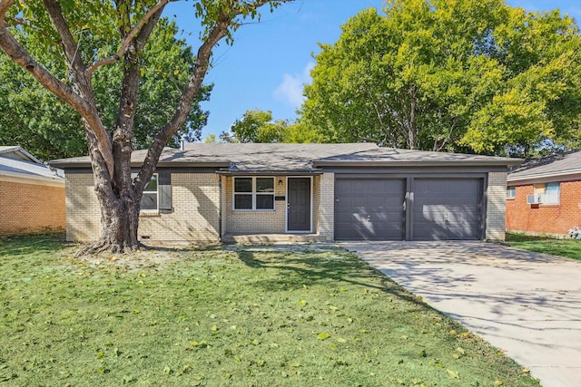 ranch-style house featuring a garage and a front lawn