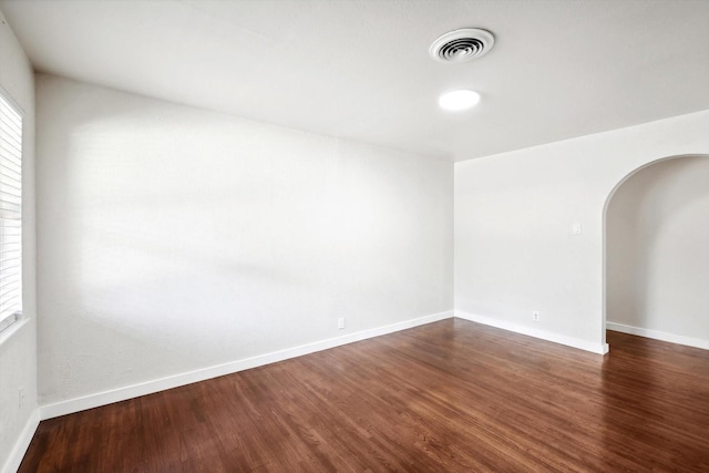 spare room with dark hardwood / wood-style flooring