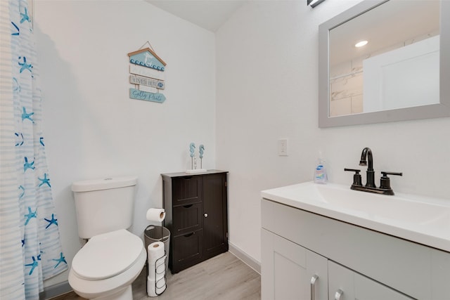 bathroom featuring a shower with curtain, vanity, toilet, and wood-type flooring