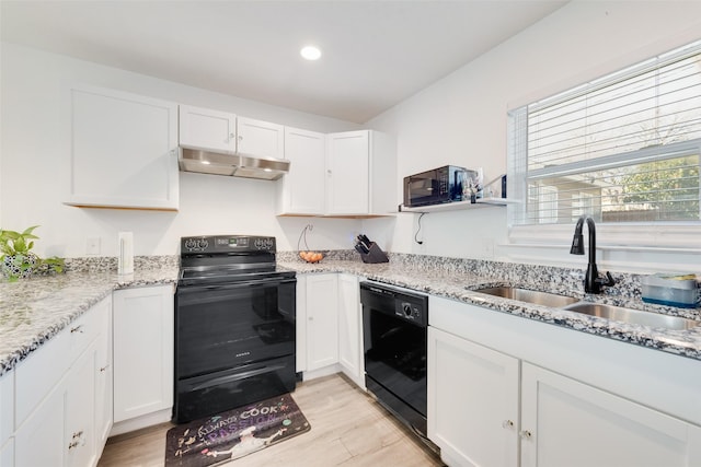 kitchen featuring black appliances, white cabinetry, sink, light hardwood / wood-style floors, and light stone counters