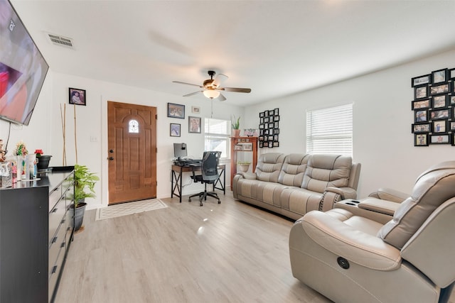 living room with ceiling fan and light hardwood / wood-style floors